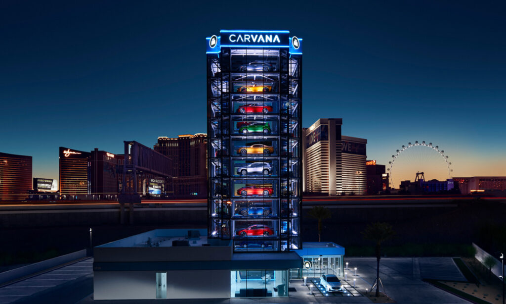 carvana car vending machine at night with logo on top is carvana