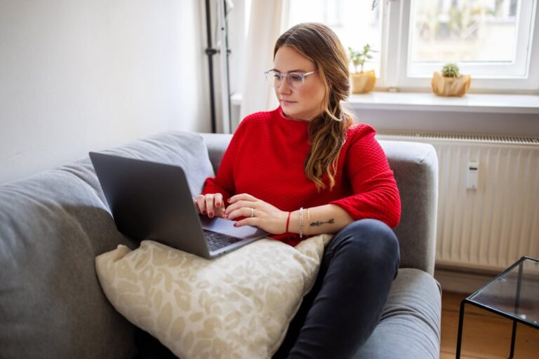 person on couch with laptop NhPfiGo