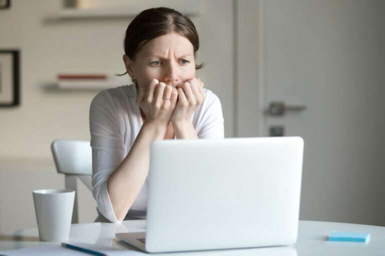 worried woman looking at laptop computer