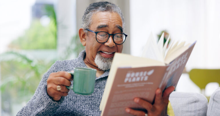 getty smiling happy reading book with mug