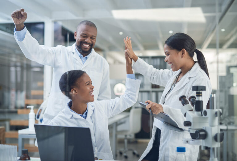 scientists high five smile