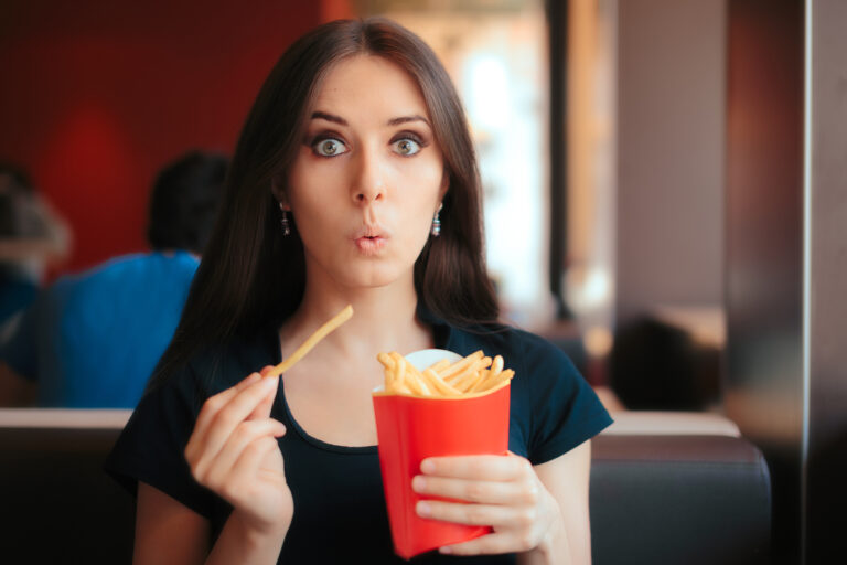 woman eating french fries