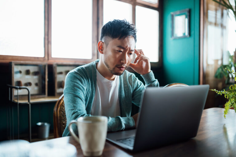 getty concerned unhappy person staring at laptop