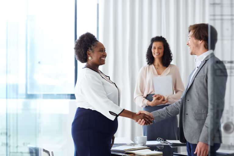 people shaking hands in an office