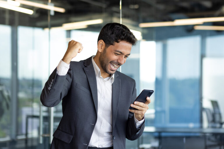 person with a mobile phone cheering