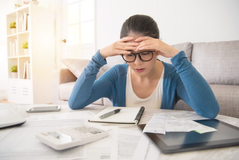 distressed investor considers papers at table