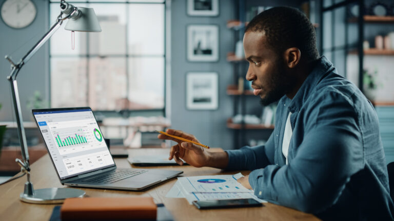 person examining a graph on their laptop