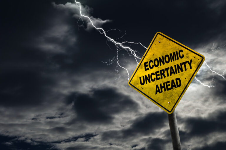 25 03 31 a road sign that reads economic uncertainty ahead with lightning in the background mf dload copy of economic turmoil ahead sign trouble volatility market 1200x800 5b2df79