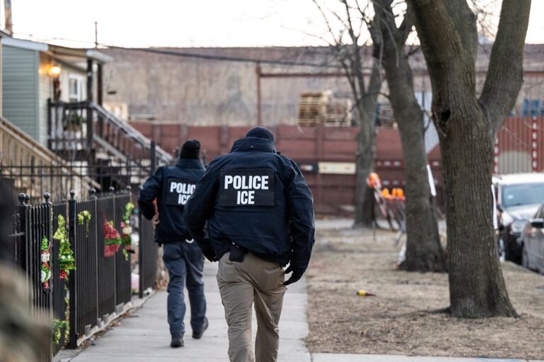 US Immigration and Customs Enforcement ICE agents walk down a street