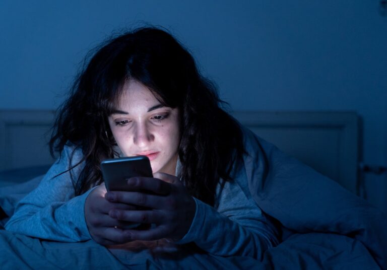 Young adult in bed on social media